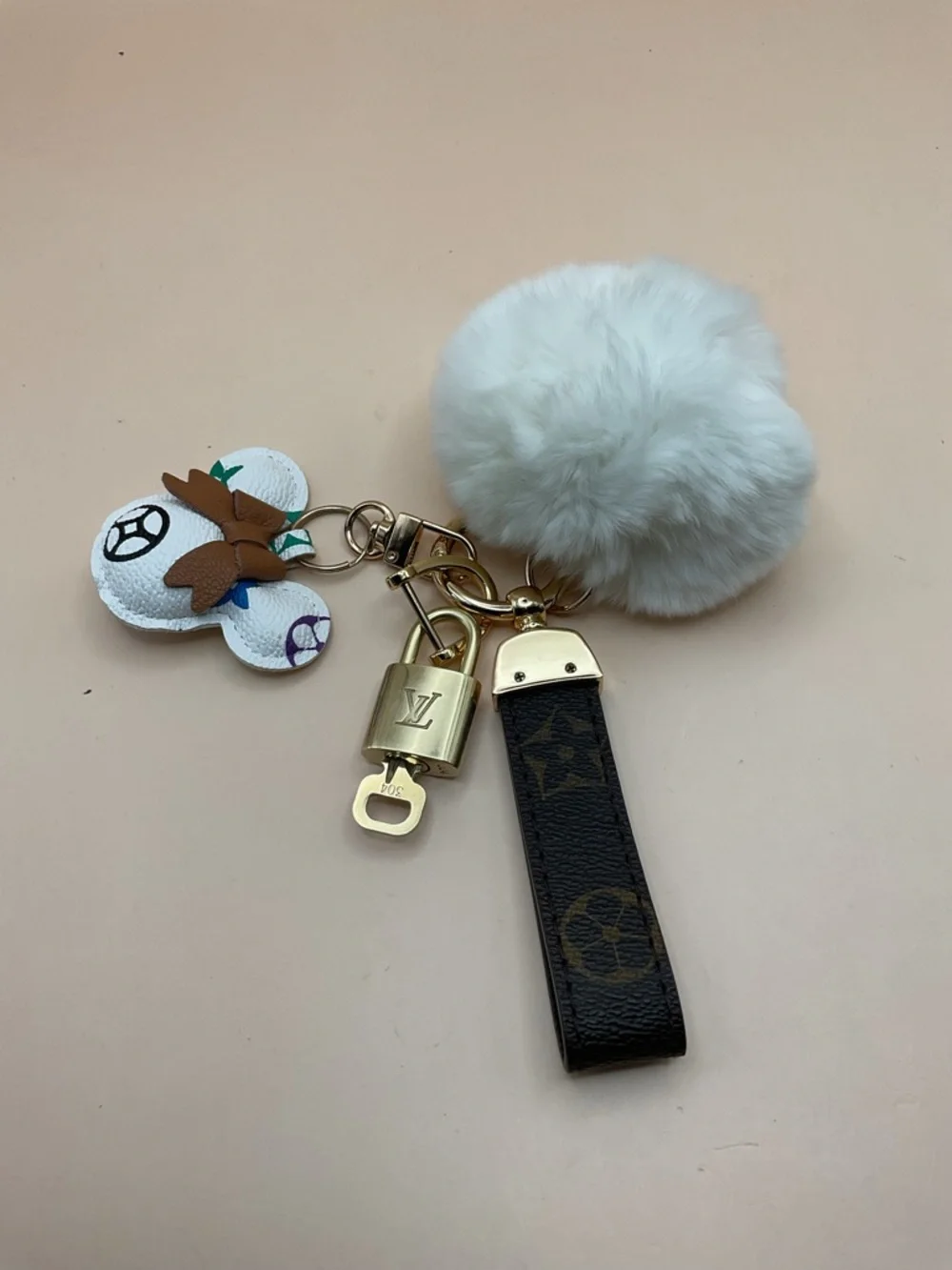 Monogram Leather Strap Keychain with Louis Vuitton Gold Lock and White Pom Pom - Picture 1 of 5